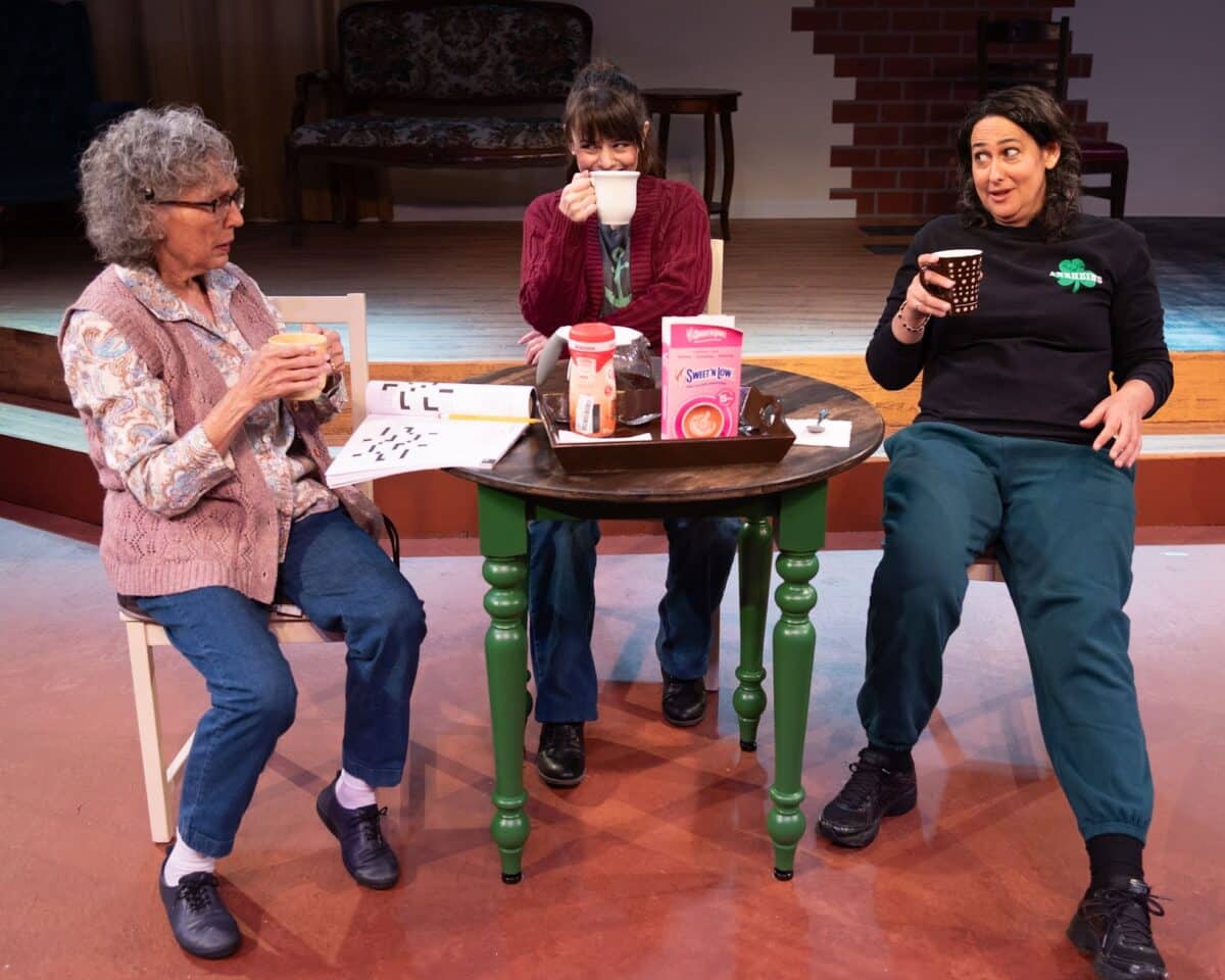 Alameda Post - three actors from Good People sit onstage around a small table and chat and smile