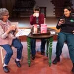 Alameda Post - three actors from Good People sit onstage around a small table and chat and smile