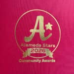 Alameda Post - A golden embossed red piece of paper with the logo for Alameda Stars 2026.
