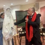 Alameda Post - On a simple set for The Christmas Carol, an actor talks with a doll representing a ghost.