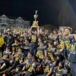 Alameda Post - Victorious Encinal High School football players hoist the Island Bowl Trophy. Photo Gabriel Caraballo.