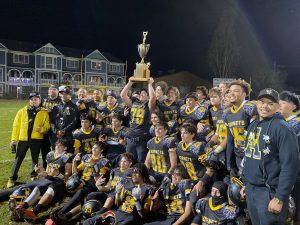 Alameda Post - Victorious Encinal High School football players hoist the Island Bowl Trophy. Photo Gabriel Caraballo.