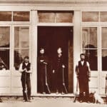Alameda Post - an old photo of six people standing in front of a store. The sign says "J. M. Browning & Bro. Guns, Pistols, Ammunition & Fishing Tackle."