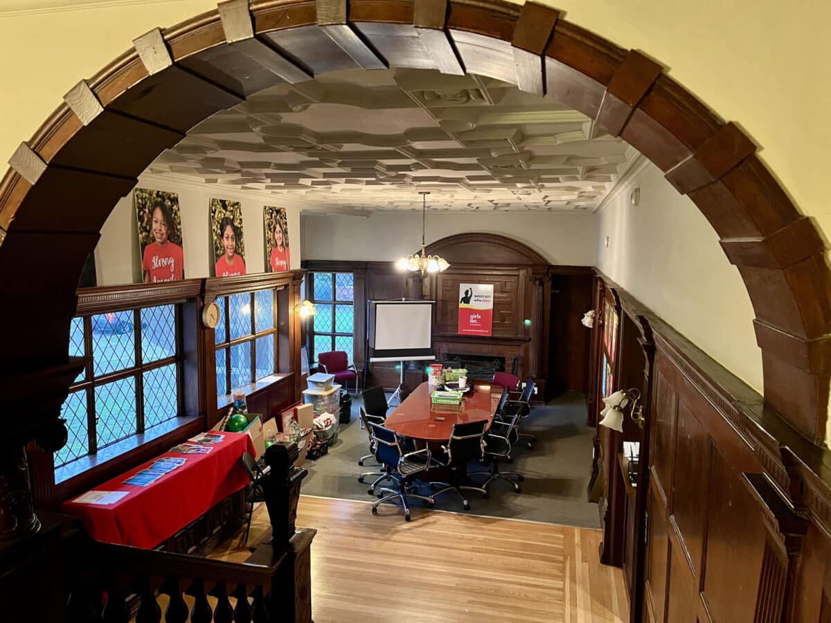 Alameda Post - A room in a beautiful old home with lots of details in dark wood, an arch, and a very detailed ceiling with lots of trim creating shapes on the ceiling. 