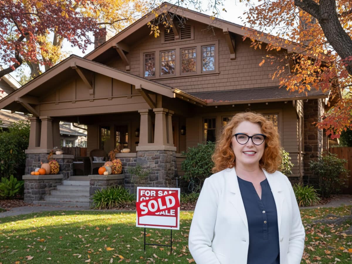 Alameda Post - Realtor® Liz Rush stands in front of a home with a sold sign on the lawn.