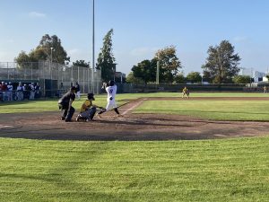 Alameda Post - an Alameda Merchants player swings at the home plate