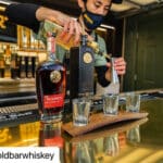 Alameda Post - a bartender pours Gold Bar Whisky at the bar at Mersea restaurant