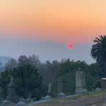 Alameda Post - Blazing red sun sets in a smoky sky over Oakland's Mountain View Cemetery on November 18, 2018