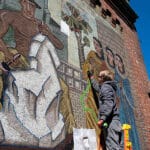 Alameda Post - Helen Bruton’s mosaic mural undergoing recent restoration work by architectural conservator Erik Sandell. Photo UC Berkeley news, https://news.berkeley.edu.