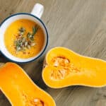 Alameda Post - a bowl of butternut squash soup next to a butternut squash