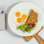 Alameda Post - a plate of sunny-side up eggs, toast, and salad