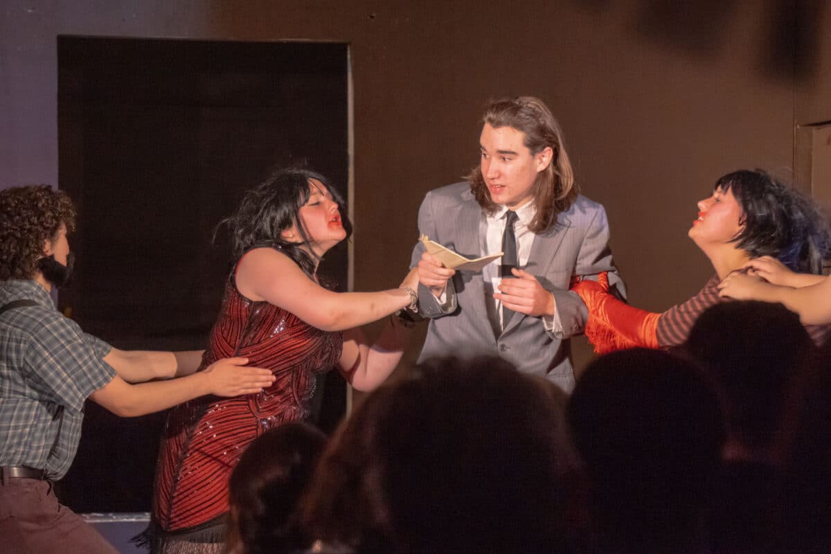 Alameda Post - Four actors onstage appear to fight over a piece of paper. 