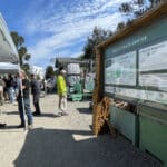 Alameda Post - community members gather next the a large sign at REAP Climate Center