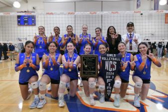 Alameda Post - the St. Joseph Notre Dame girls volleyball team poses together and hold a plaque that says "North Coast Section Championships," and several other words too small to read. They also hold a flag that says "Girls Volleyball NCS 2024 DIV 3 First"