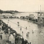 Alameda Post - A crowded pool at Neptune Beach. Swimmers enjoy the water, and an ocean is in the background