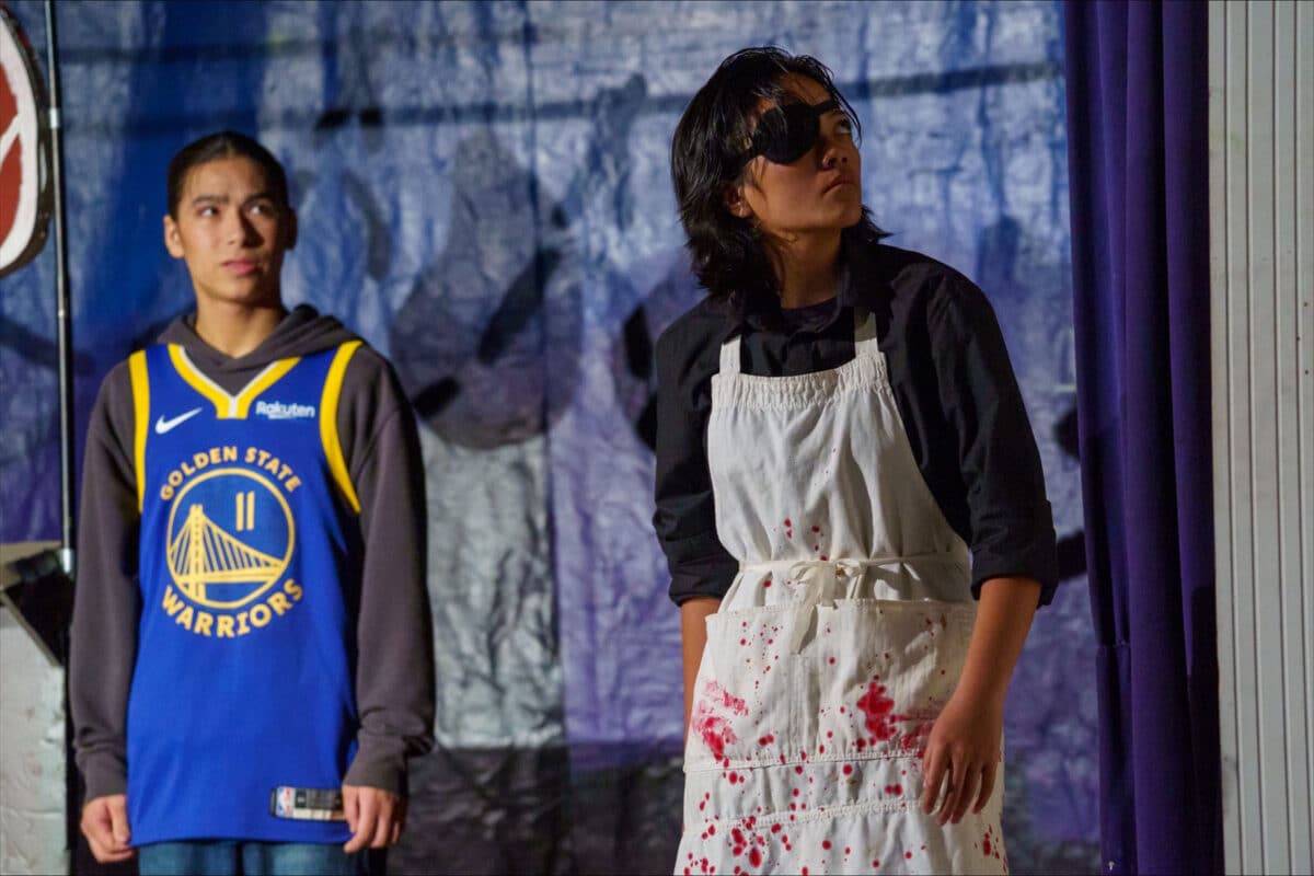 Alameda Post - Two actors in Anonymous. One is in a butcher's costume and the other wears a Warriors jersey. 