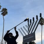 Alameda Post -a Rabbi lights a menorah in Washington Park