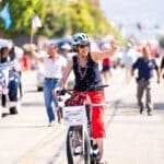 Alameda Post - Alameda Mayor Ashcraft rides a bicycle in the 4th of July Parade