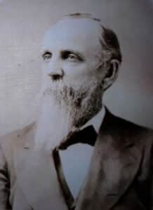 Alameda Post - a black and white photo of a man in a suit with a long white beard