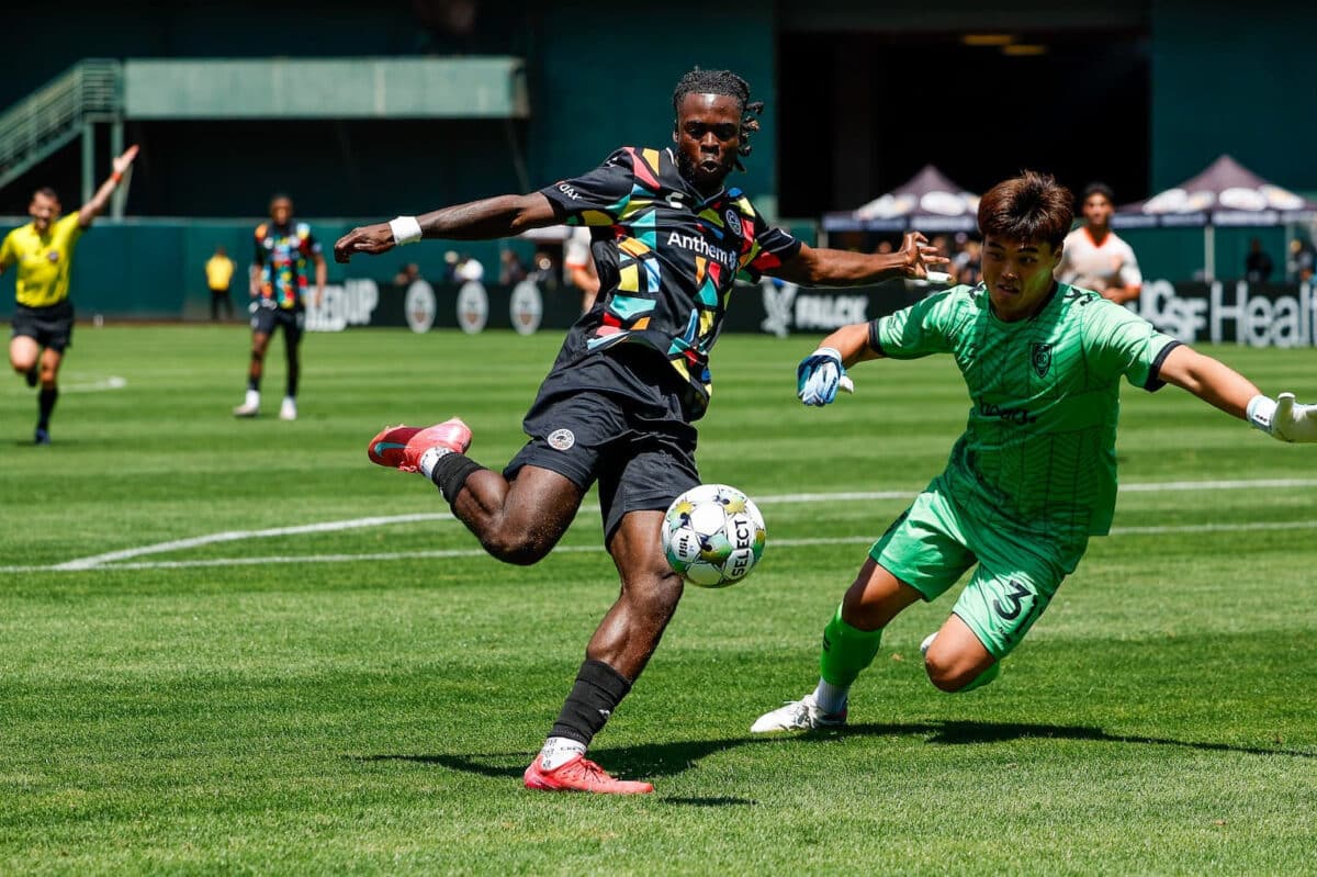 Alameda Post - an Oakland Roots player and a Orange County SC player both go for the ball