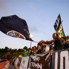 Alameda Post - an excited fan waves an Oakland Roots flag