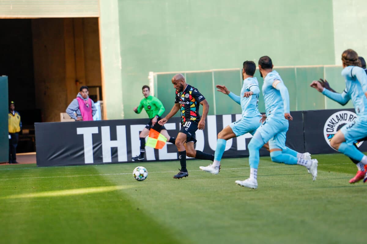 Alameda Post - an Oakland Roots player keeps the ball away from Monterey Bay FC