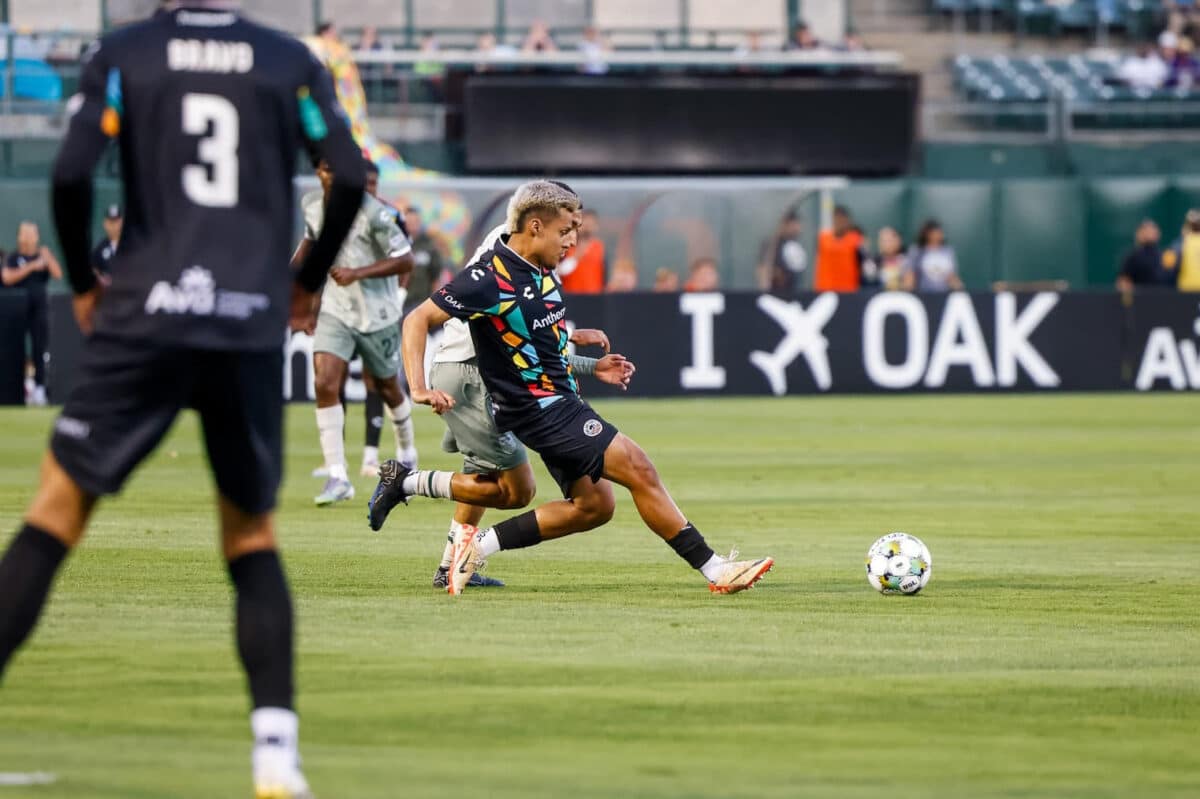 Alameda Post - an Oakland Roots player goes for the ball in a match againstMonterey Bay FC