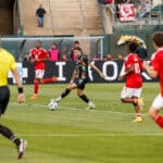 Alameda Post -an Oakland Roots player dribbles the ball in a match against Phoenix Rising FC