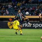 Alameda Post - an Oakland Roots player jumps for the ball in a match against New Mexico United