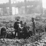 Alameda Post - men stand around the ruins of the 1906 San Francisco earthquake and try to open a safe