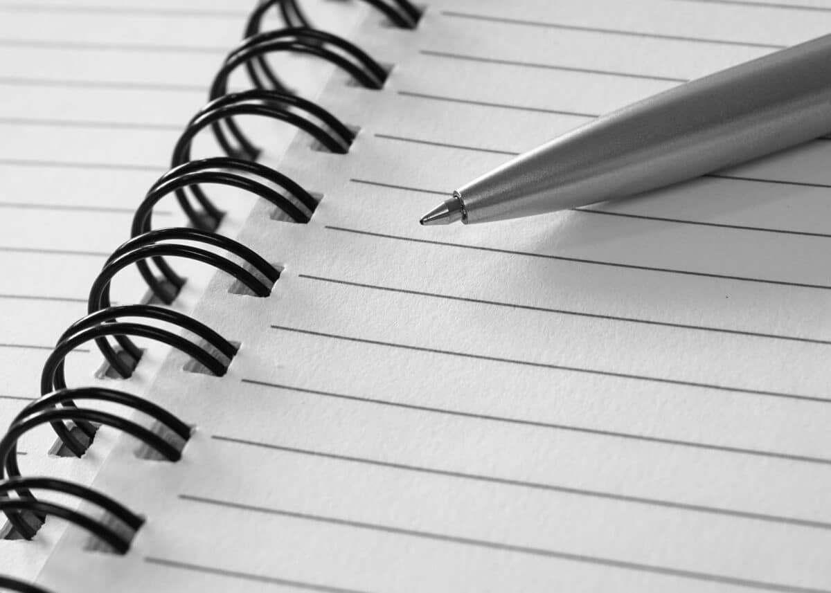 Alameda Post - a pen on an open lined notebook. 