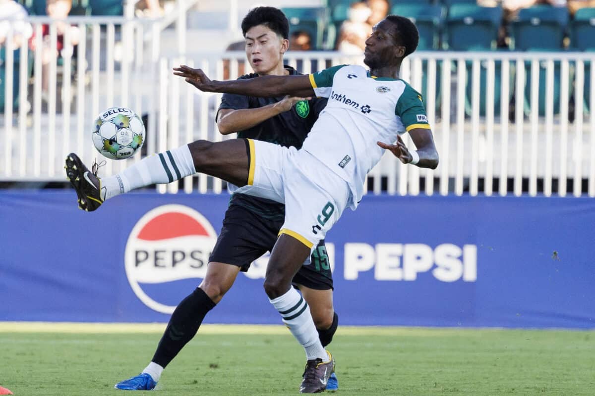 Alameda Post - an Oakland Roots player sticks their leg up high to get a ball in the match against Lexington SC