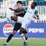 Alameda Post - an Oakland Roots player sticks their leg up high to get a ball in the match against Lexington SC