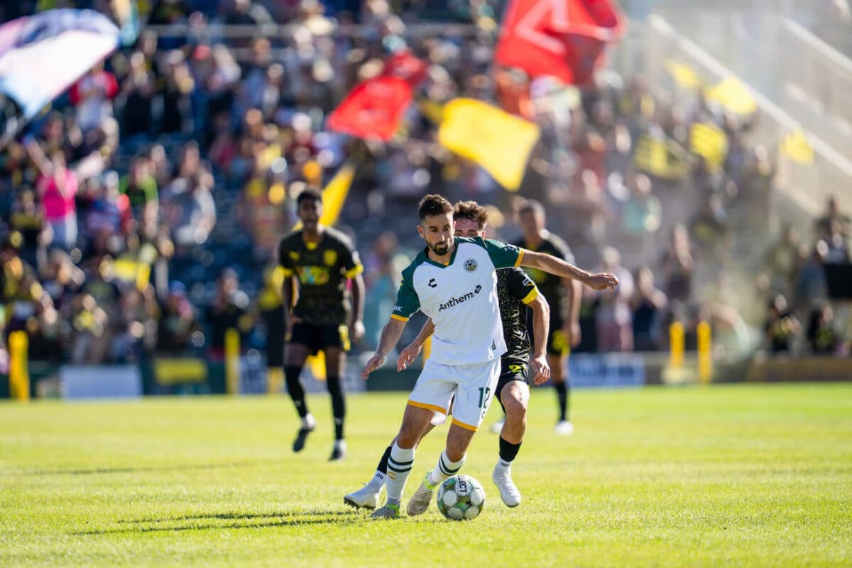 Alameda Post - An Oakland Roots player dribbles the ball against New Mexico United.