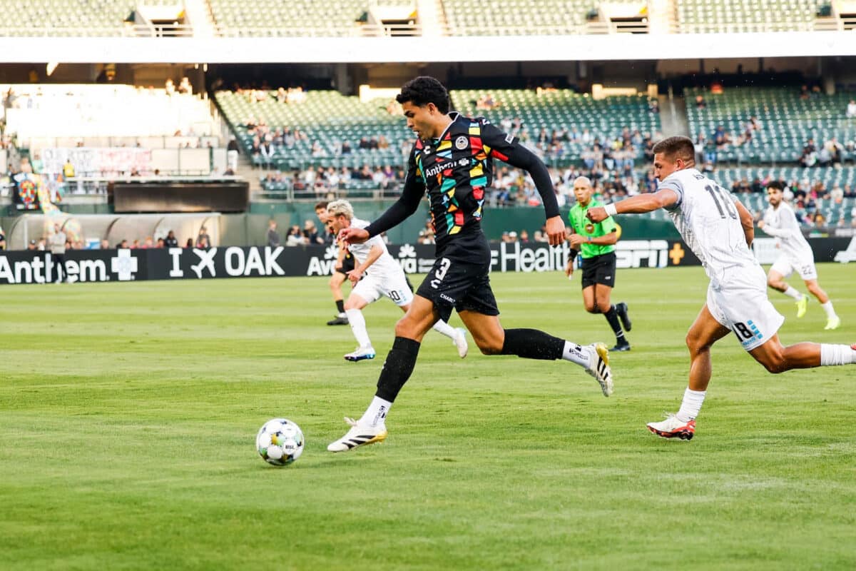 Alameda Post - an Oakland Roots player goes for the ball in the match against Colorado Springs Switchbacks FC