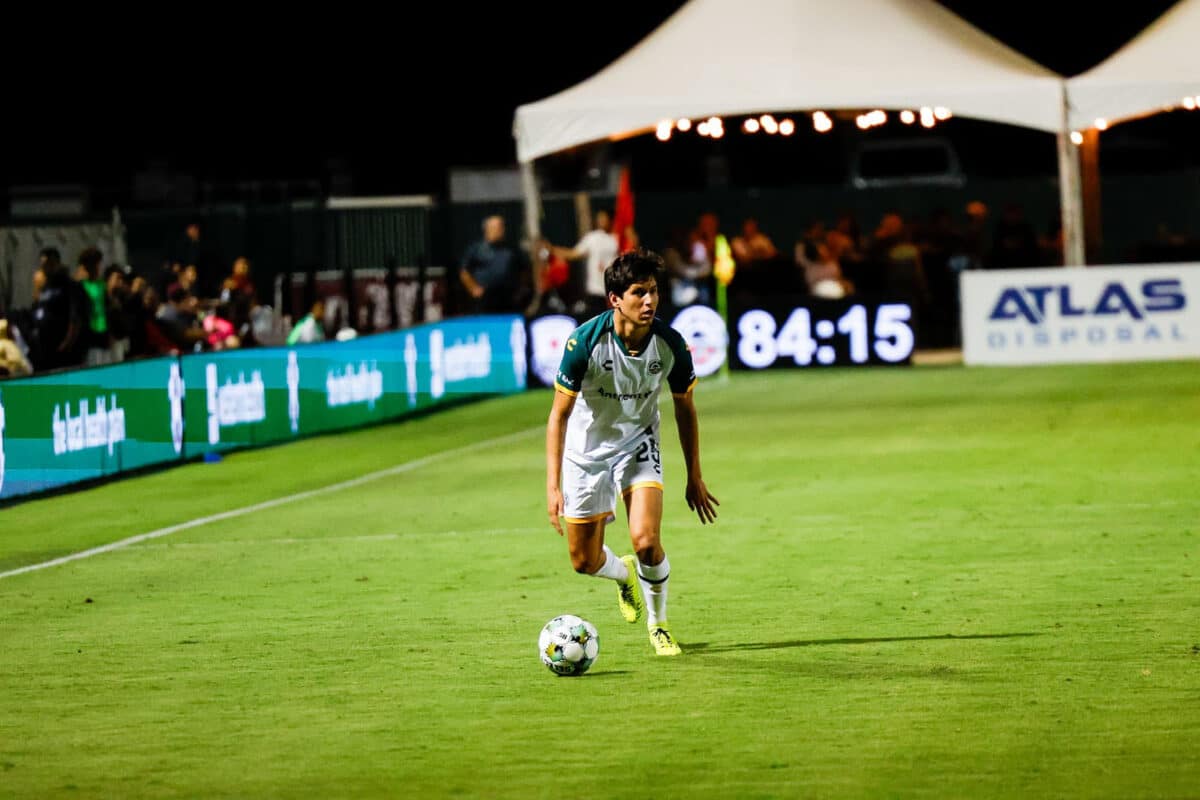 Alameda Post - an Oakland Roots player dribbles the ball in a match against Sacramento Republic FC