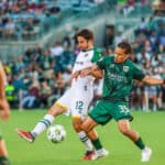 Alameda Post - an Oakland Roots and AV Alta FC player vie for the ball