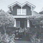 Alameda Post - a black and white photo of a home an a family on the steps in front