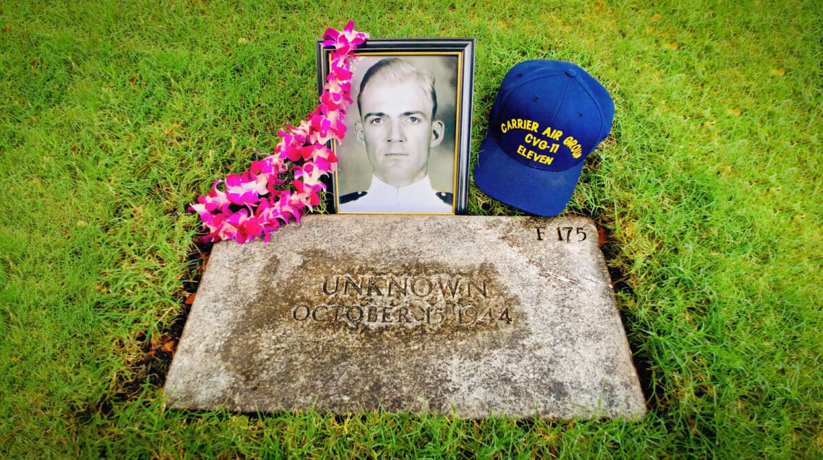Alameda Post - An unknown soldier's grave that has since been decorated with a photo, hat, and lei. 