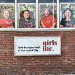 Alameda Post - The side of the Greenleaf House with the Girls Inc sign and photos of young girls who have participated in the windows.