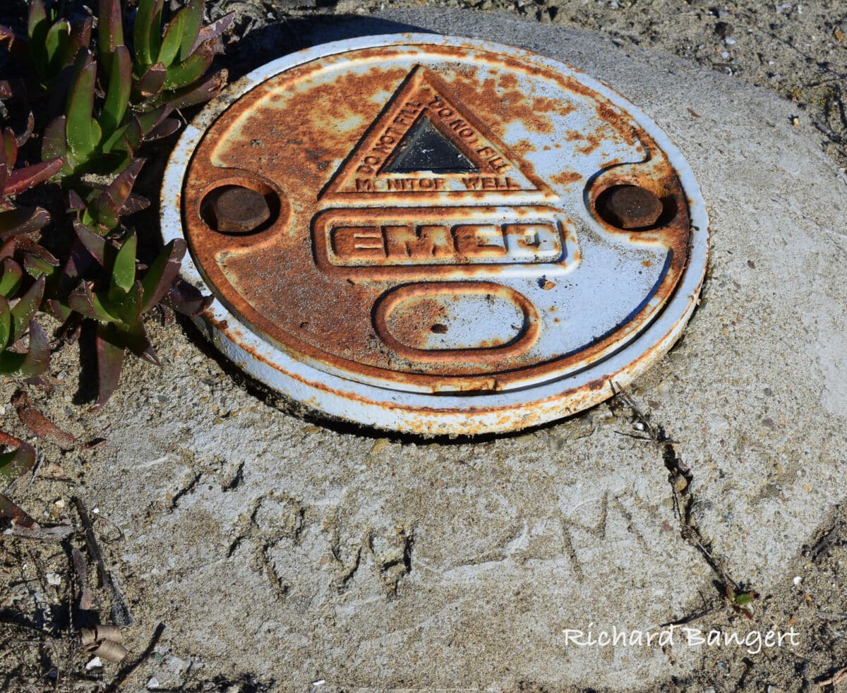 Alameda Post - A metal marker attached to a concrete piece on the group with the words "Do not fill. Monitor Well. EMCO."