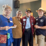 Alameda Post - four people pose together at the Meals on Wheels anniversary celebration