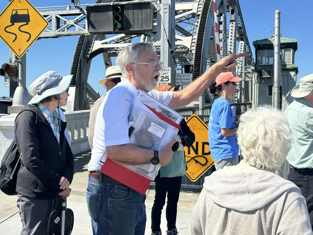 Alameda Post - Dennis Evanosky leads a history walking tour at the Park Street Bridge in 2024.
